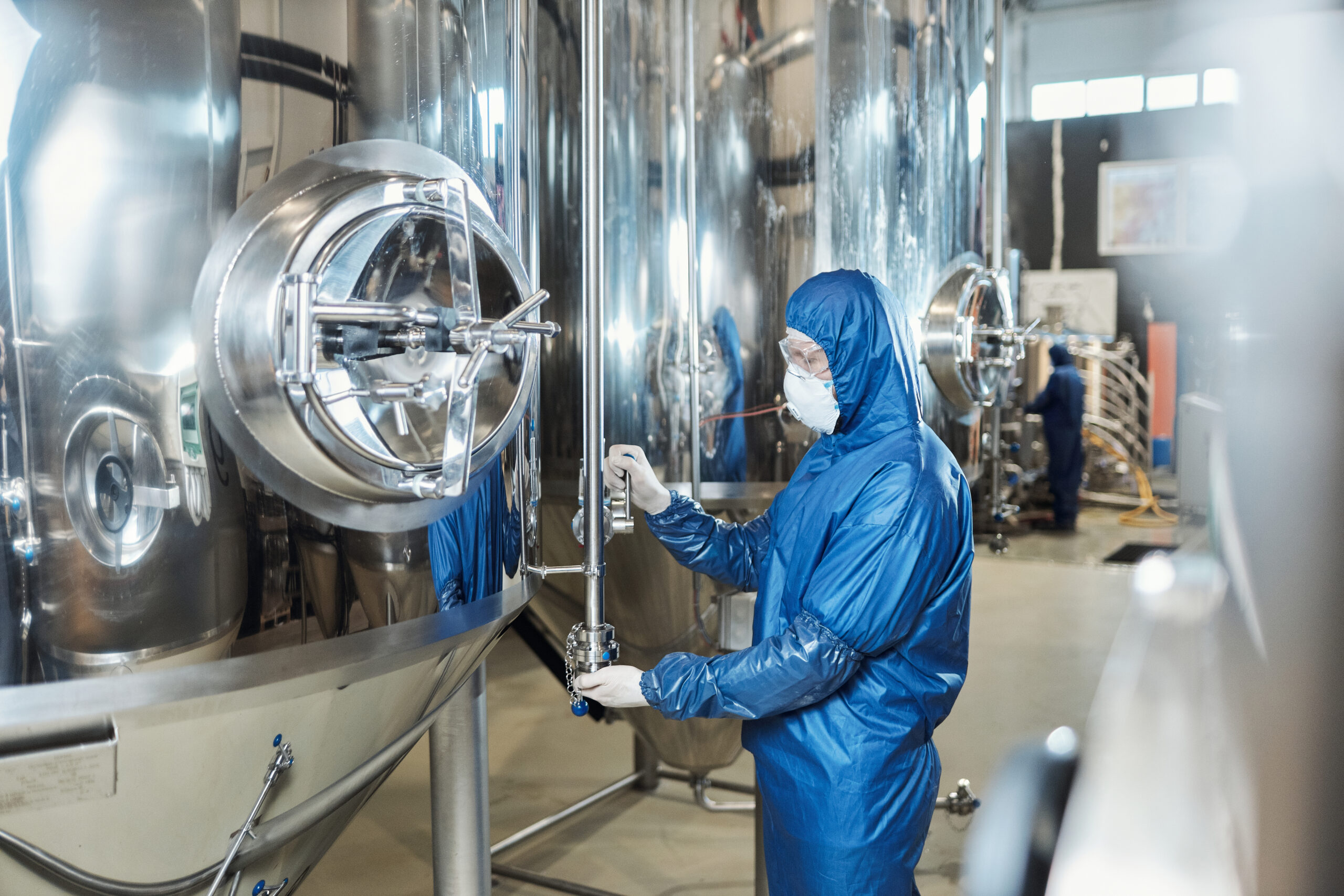 Side view of worker wearing protective gear at chemical plant